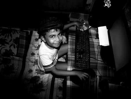 Smiling Boy Using Computer - Black and White - Free Stock Photo