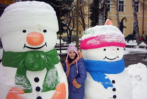 Free Stock Photo of Snowmen and a girl