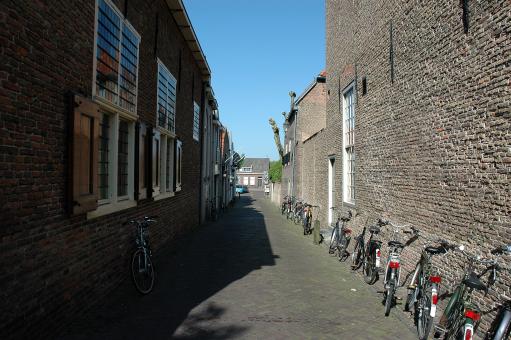 Free Stock Photo of Alley with parked bicycles
