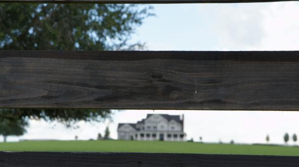 Free Stock Photo of Farmhouse through the fence