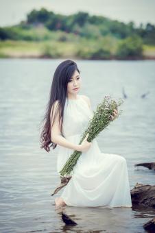 Free Stock Photo of The Girl Holding the Tunic