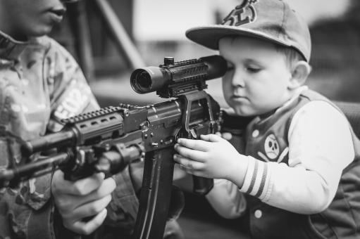 Free Stock Photo of Kid using a Gun