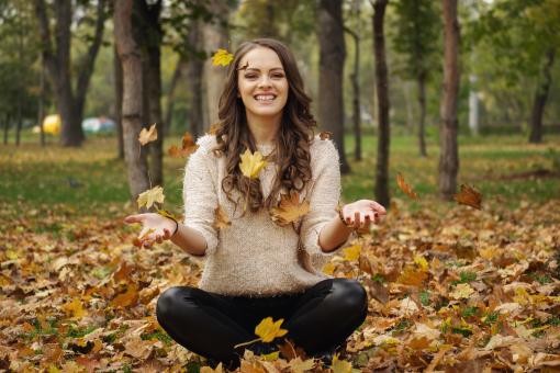 Free Stock Photo of Girl and Fall Leaves, Smiling and Playing