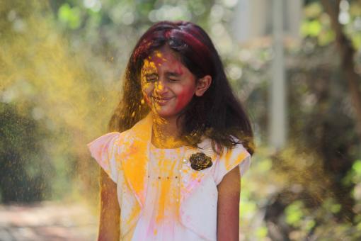 Free Stock Photo of Young Girl Covered in Yellow Powder