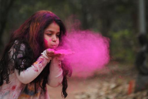 Free Stock Photo of Young Girl Blowing Pink Powder