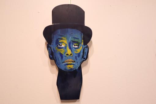 Free Stock Photo of Graffiti portrait of man with hat in an art gallery