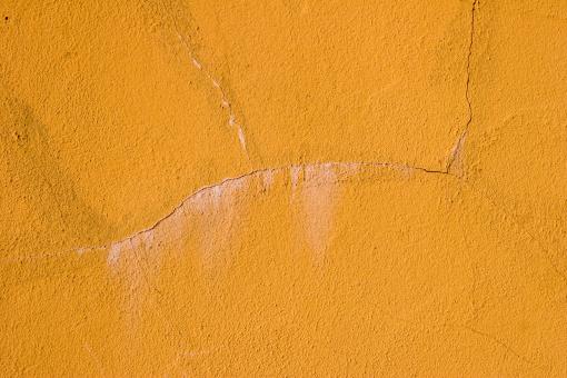 Free Stock Photo of Cracked Yellow Wall Texture