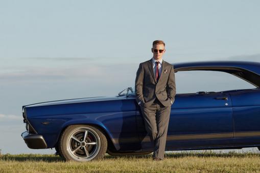 Free Stock Photo of Man Standing Against a Blue Car