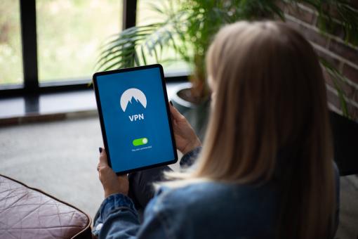 Free Stock Photo of Woman holding tablet with VPN software