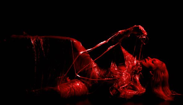Free Stock Photo of Woman Wrapped in Plastic - Black and Red