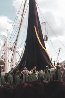 Free Stock Photo of Sailors Working on Netting