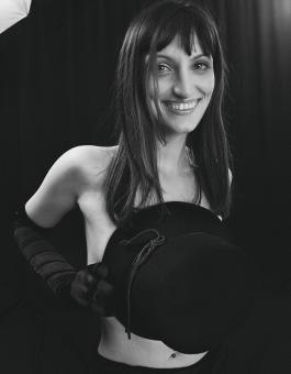 Free Stock Photo of Smiling Girl Holding a Hat - Black and White