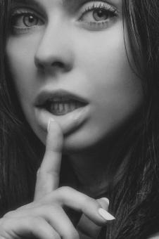 Free Stock Photo of Model with Finger on Lip - Black and White Portrait