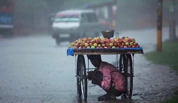 Free Stock Photo of A Poor Vendor is Hiding from Rain