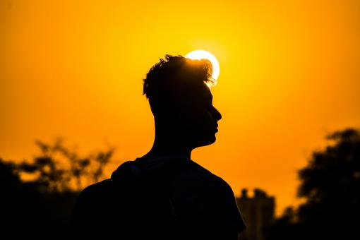 Free Stock Photo of Silhouette of Man with Sun in Background