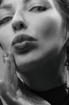 Free Stock Photo of Woman Blowing a Kiss - Monochrome Portrait
