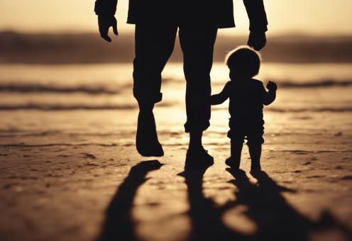 Free Stock Photo of Silhouette of Father Holding His Son's Hand