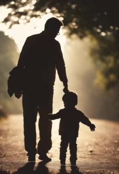 Free Stock Photo of Silhouette of Father Holding His Son's Hand