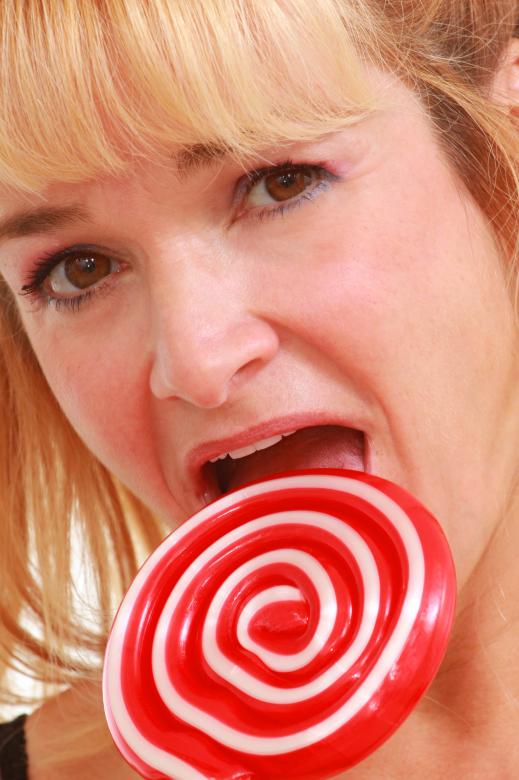 Free stock image of Woman enjoying a lollipop created by Val Lawless