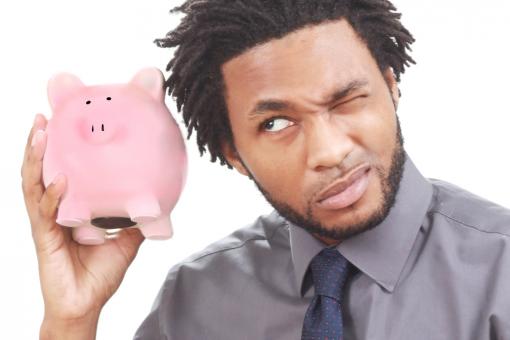 Man shaking a piggy bank - Free Stock Photo