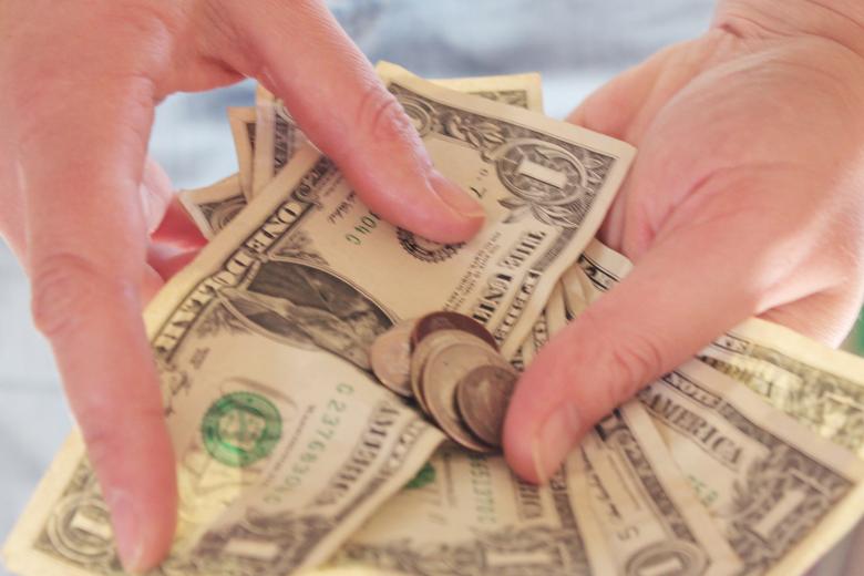 Free stock image of Money in hands created by Val Lawless