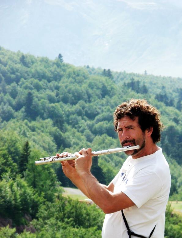 Free stock image of Man playing the flute in the mountains created by Luka
