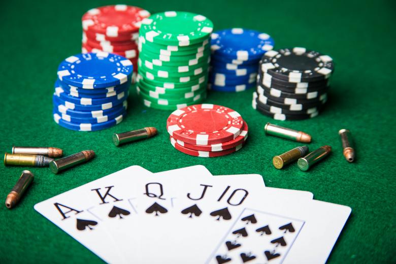 Free stock image of Royal Flush with bullets and poker chips created by Jared Davidson
