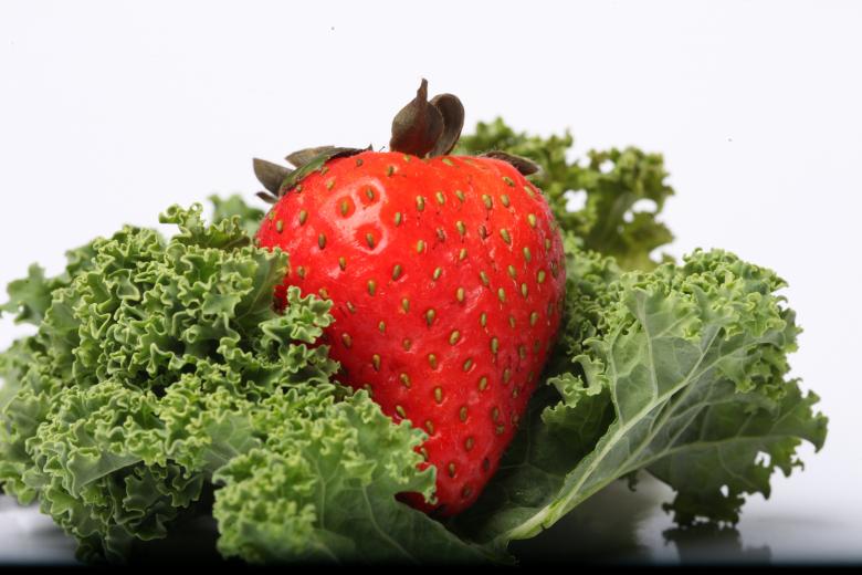 Free stock image of Red Strawberry on kale created by Jared Davidson