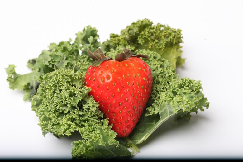 Free stock image of Red Strawberry on kale created by Jared Davidson