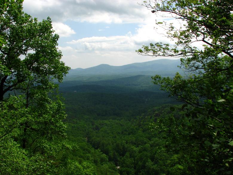 Free stock image of Mountain landscape viewed through trees created by Benjamin Miller