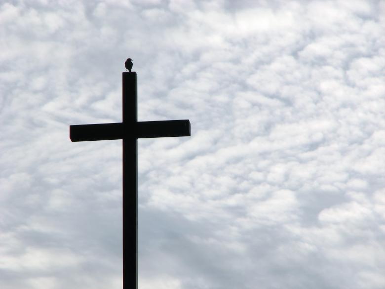 Free stock image of A cross before a cloudy sunset sky created by Benjamin Miller
