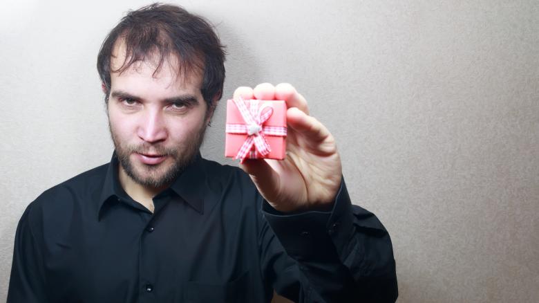 Free stock image of young man holding a gift  created by Mudretsov Olexandr
