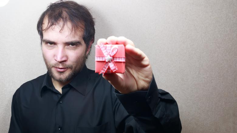 Free stock image of young man holding a gift  created by Mudretsov Olexandr