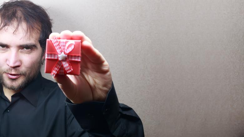 Free stock image of young man holding a gift  created by Mudretsov Olexandr