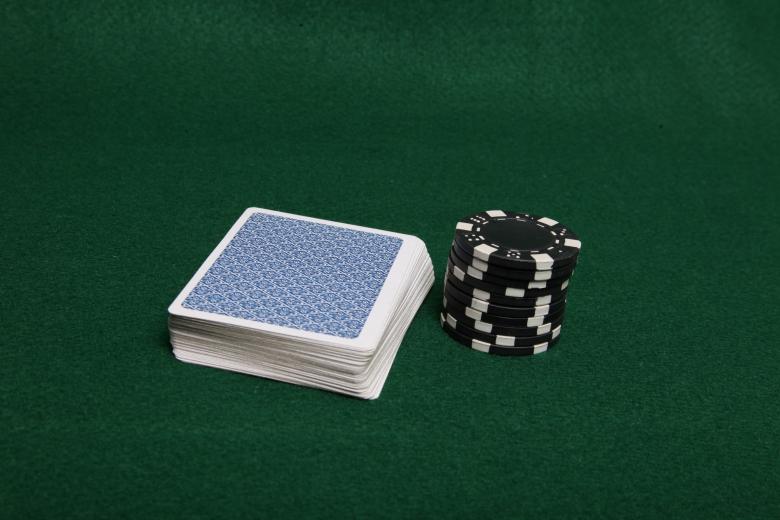 Free stock image of Stack of black poker chips next to cards created by Jared Davidson