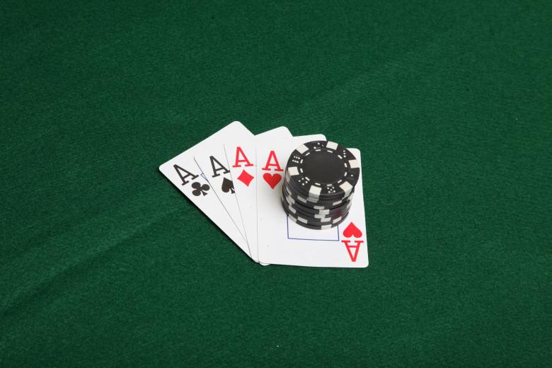 Free stock image of Stack of black poker chips on four aces. created by Jared Davidson