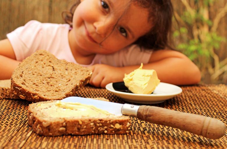 Free stock image of Child preparing to eat bread and butter created by Jack Moreh