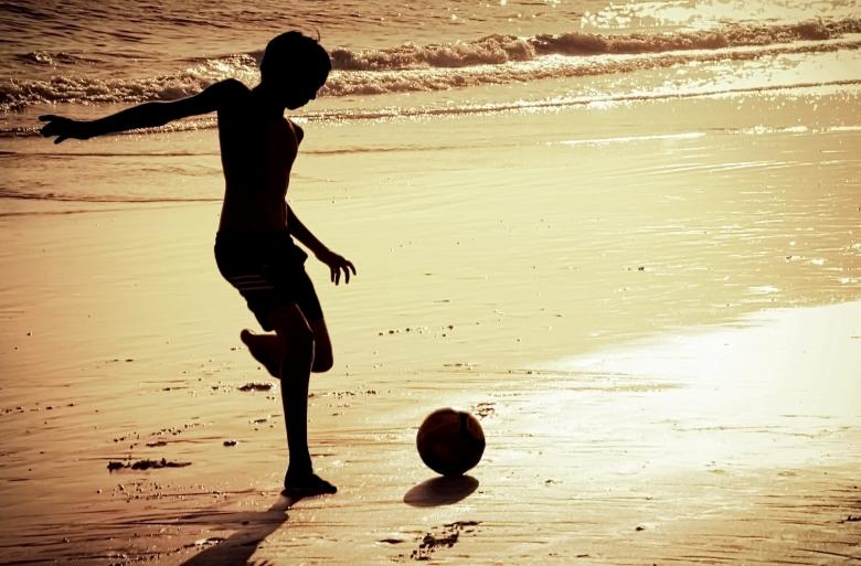 Free stock image of Boy on the beach playing football created by Jack Moreh
