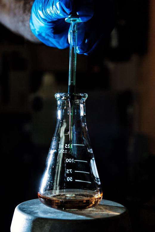 Free stock image of Person adding chemicals to a flask created by Geoffrey Whiteway