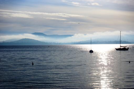Free Stock Photo of Cloudy Mountains and Still Ocean