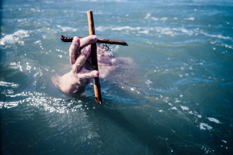 Free stock image of Swimmer holding a cross created by Unsplash