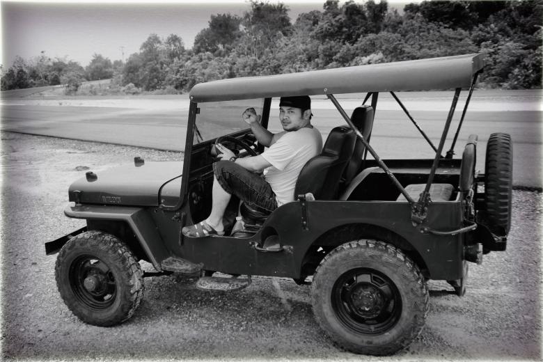 Free stock image of Man in Willy's Jeep created by Satrio aribowo