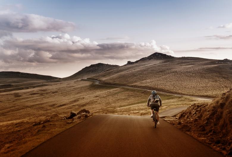 Free stock image of  Lone Biker on the Road Through Mountains created by Jack Moreh