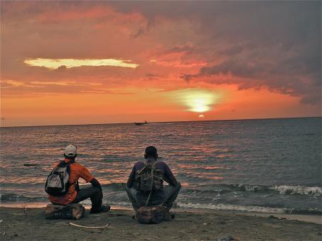 2 Men Watching the Sunset on Beach - Free Stock Photo