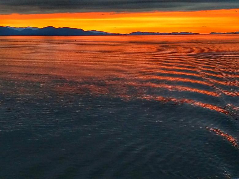 Free stock image of Sunset Over Ripples at Sea created by agphotostock.com