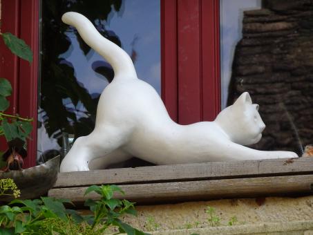 Even porcelain cats love to stretch!! - Free Stock Photo