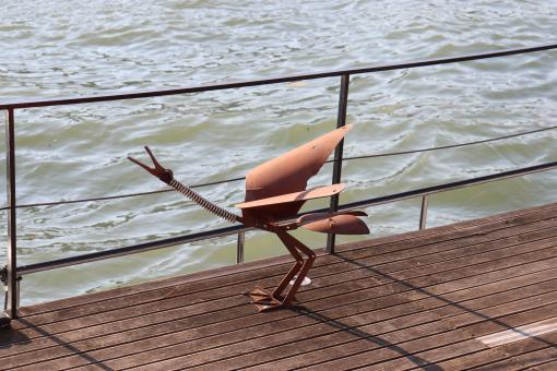 Iron bird on a river boat - Free Stock Photo