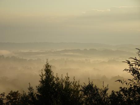 Foggy and cloudy sunrise above the valley - Free Stock Photo