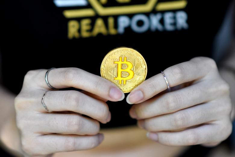 Free stock image of Female holding a single bitcoin created by Photography Art