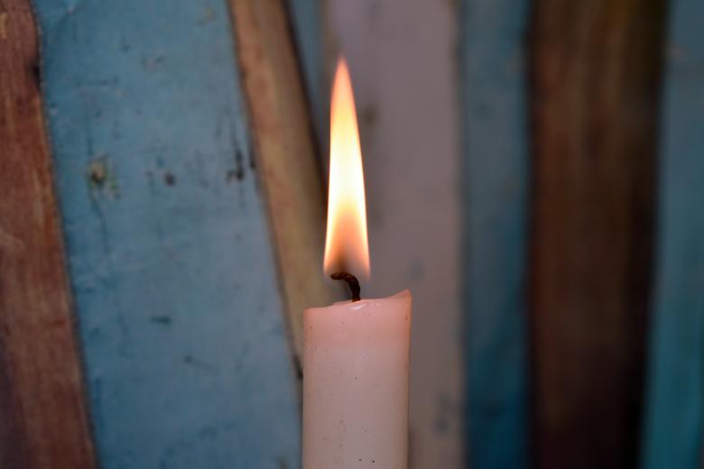 Free stock image of Candle and multi-coloured background behind it created by NomeVizualizzato
